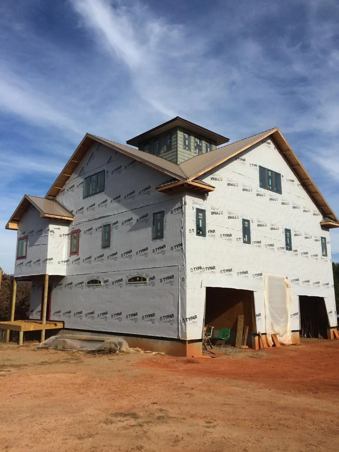 New two story house under construction with a cupola and gabled roofs in Encinitas